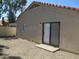 Backyard featuring a sliding glass door entry to home and low maintenance desert landscaping at 1450 E Laurel Ave, Gilbert, AZ 85234