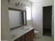 Bright bathroom with a double sink vanity, a large mirror, and tile flooring at 1450 E Laurel Ave, Gilbert, AZ 85234