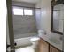 Updated bathroom with a tub and shower combination featuring modern, neutral-toned tile surround at 1450 E Laurel Ave, Gilbert, AZ 85234