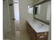 Bright bathroom features a long double sink vanity and tile flooring at 1450 E Laurel Ave, Gilbert, AZ 85234
