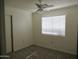 Bright bedroom with ceiling fan, neutral paint, new carpet, and a window with blinds at 1450 E Laurel Ave, Gilbert, AZ 85234