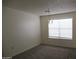 Neutral bedroom with new carpet, a chandelier, and a large window at 1450 E Laurel Ave, Gilbert, AZ 85234
