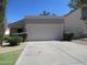 Spacious driveway leading to a two-car garage with well-maintained landscaping at 1450 E Laurel Ave, Gilbert, AZ 85234