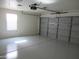 Clean, freshly painted garage with epoxy floor, garage door, and natural light at 1450 E Laurel Ave, Gilbert, AZ 85234