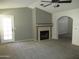 Cozy living room with a tiled fireplace, neutral paint, ceiling fan, and access to the backyard at 1450 E Laurel Ave, Gilbert, AZ 85234