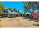 Large backyard featuring a covered porch, storage shed, mature trees, and vibrant bougainvillea at 14622 N 45Th Pl, Phoenix, AZ 85032