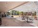 Expansive backyard includes covered patio, seating area, pergola, and fire pit at 14622 N 45Th Pl, Phoenix, AZ 85032