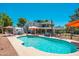 Large in-ground pool with seating and an orange sun umbrella at 14622 N 45Th Pl, Phoenix, AZ 85032
