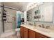 Bathroom featuring double sinks, tub and shower combo with white marble-style tile and blue shower curtain at 14622 N 45Th Pl, Phoenix, AZ 85032