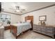 Comfortable bedroom with light-gray walls, an ornate bed, and gray painted dresser with decor at 14622 N 45Th Pl, Phoenix, AZ 85032