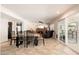 Open concept dining and living area filled with natural light, tile floors, and a fireplace at 14622 N 45Th Pl, Phoenix, AZ 85032