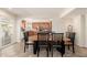 A dining room with tile flooring adjacent to the kitchen and views of the outdoor area at 14622 N 45Th Pl, Phoenix, AZ 85032