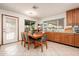 Eat-in kitchen with wood table and chairs, and view of the backyard at 14622 N 45Th Pl, Phoenix, AZ 85032