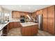 This spacious kitchen features wood cabinets, stainless steel appliances, and a large island with granite countertops at 14622 N 45Th Pl, Phoenix, AZ 85032