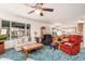 Living room with plenty of seating, large windows, and a ceiling fan at 14622 N 45Th Pl, Phoenix, AZ 85032