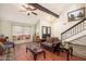 Open-concept living room with hardwood floors, high ceilings, and a staircase leading to the second floor at 14622 N 45Th Pl, Phoenix, AZ 85032