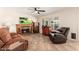 A cozy living room with a fireplace and a large window overlooking the backyard at 14622 N 45Th Pl, Phoenix, AZ 85032