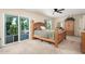 Main bedroom featuring a large bed, balcony access, and neutral decor at 14622 N 45Th Pl, Phoenix, AZ 85032