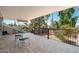 Covered patio with tile flooring, iron railing overlooking landscaped backyard with mature trees at 14622 N 45Th Pl, Phoenix, AZ 85032