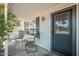 Covered front porch with seating and a screen door, offering a relaxing outdoor space at 14622 N 45Th Pl, Phoenix, AZ 85032