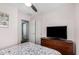 Cozy bedroom features a ceiling fan, closet, television, and ensuite access at 14885 W Ashland Ave, Goodyear, AZ 85395