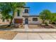 Inviting two-story home featuring low maintenance landscaping and a charming brick facade at 14885 W Ashland Ave, Goodyear, AZ 85395