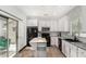 Bright kitchen with white cabinets, modern appliances and a moveable island at 14885 W Ashland Ave, Goodyear, AZ 85395