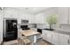 Bright kitchen with white cabinets, modern appliances and a moveable island at 14885 W Ashland Ave, Goodyear, AZ 85395