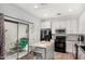 Bright kitchen features a center island, stainless steel appliances, and access to an outdoor patio at 14885 W Ashland Ave, Goodyear, AZ 85395