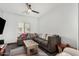 Comfortable living room with a ceiling fan, a large sectional couch and natural light at 14885 W Ashland Ave, Goodyear, AZ 85395