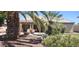 Gorgeous backyard featuring a refreshing pool, patio area, and mature palm trees at 15861 W Westview Dr, Goodyear, AZ 85395