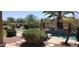 Resort-style backyard with a stunning pool, tropical palms, and shaded lounge area at 15861 W Westview Dr, Goodyear, AZ 85395