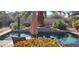 Relaxing poolside view with colorful flowers, comfortable seating, and lush greenery at 15861 W Westview Dr, Goodyear, AZ 85395