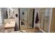 Bathroom features dual sinks, tiled floors, shower, and mirrored closet at 15861 W Westview Dr, Goodyear, AZ 85395