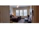 Comfortable bedroom featuring ceiling fan, seating area and shuttered windows at 15861 W Westview Dr, Goodyear, AZ 85395