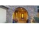Stone archway leads to an inviting front porch with seating area and decorative door at 15861 W Westview Dr, Goodyear, AZ 85395