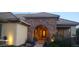 Close-up of stone archway leading to front door, framed by lush greenery and plants at 15861 W Westview Dr, Goodyear, AZ 85395