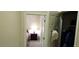 Neutral hallway featuring closet space and access to bedroom at 15861 W Westview Dr, Goodyear, AZ 85395