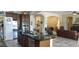 Kitchen with stainless steel appliances and island overlooking an archway at 15861 W Westview Dr, Goodyear, AZ 85395