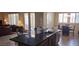 Kitchen island with stainless steel appliances, breakfast nook and an open concept to the living room at 15861 W Westview Dr, Goodyear, AZ 85395