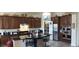 Spacious kitchen with dark wood cabinets, granite countertops, and stainless steel appliances at 15861 W Westview Dr, Goodyear, AZ 85395