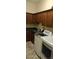 Laundry room with dark wood cabinets, sink, and modern washer and dryer units at 15861 W Westview Dr, Goodyear, AZ 85395