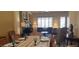 Open-concept living and dining area with fireplace and shuttered windows at 15861 W Westview Dr, Goodyear, AZ 85395