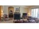 Cozy living room with fireplace, dark wood accents, and elegant decor at 15861 W Westview Dr, Goodyear, AZ 85395