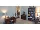 Dedicated home office space, complete with a wooden desk, chair, and bookcase at 15861 W Westview Dr, Goodyear, AZ 85395