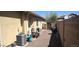 Outdoor patio with gravel, barbecue and utilities behind a stucco house at 15861 W Westview Dr, Goodyear, AZ 85395