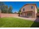 This backyard features a well-manicured lawn, neutral stucco, covered patio and privacy wall at 16626 N 20Th St, Phoenix, AZ 85022