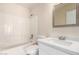 Bright bathroom with white vanity, tile tub and shower combo at 16626 N 20Th St, Phoenix, AZ 85022