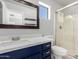 Bathroom featuring navy vanity with white countertop and glass-enclosed shower at 16626 N 20Th St, Phoenix, AZ 85022