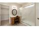 Bathroom featuring a vanity area, lighted mirror, and walk-in shower at 17009 W Eureka Springs Dr, Surprise, AZ 85387